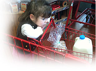 Little girl eating corn.