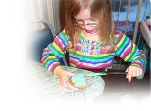 little girl making cupcakes