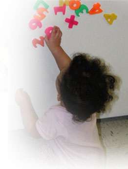 Little girl playing with letter magnets